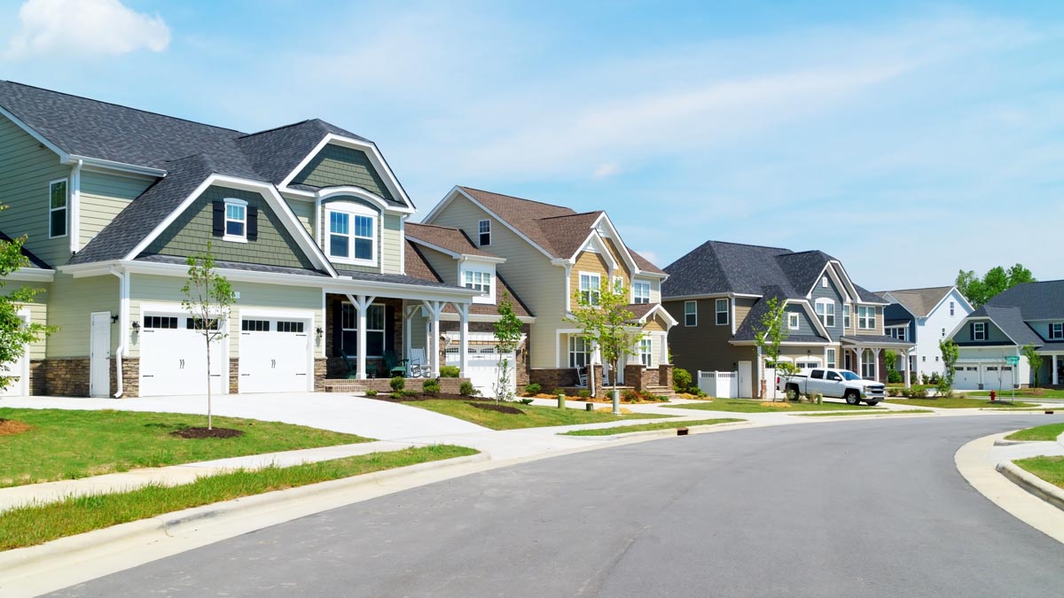 A row of two-story houses along a curved suburban street.