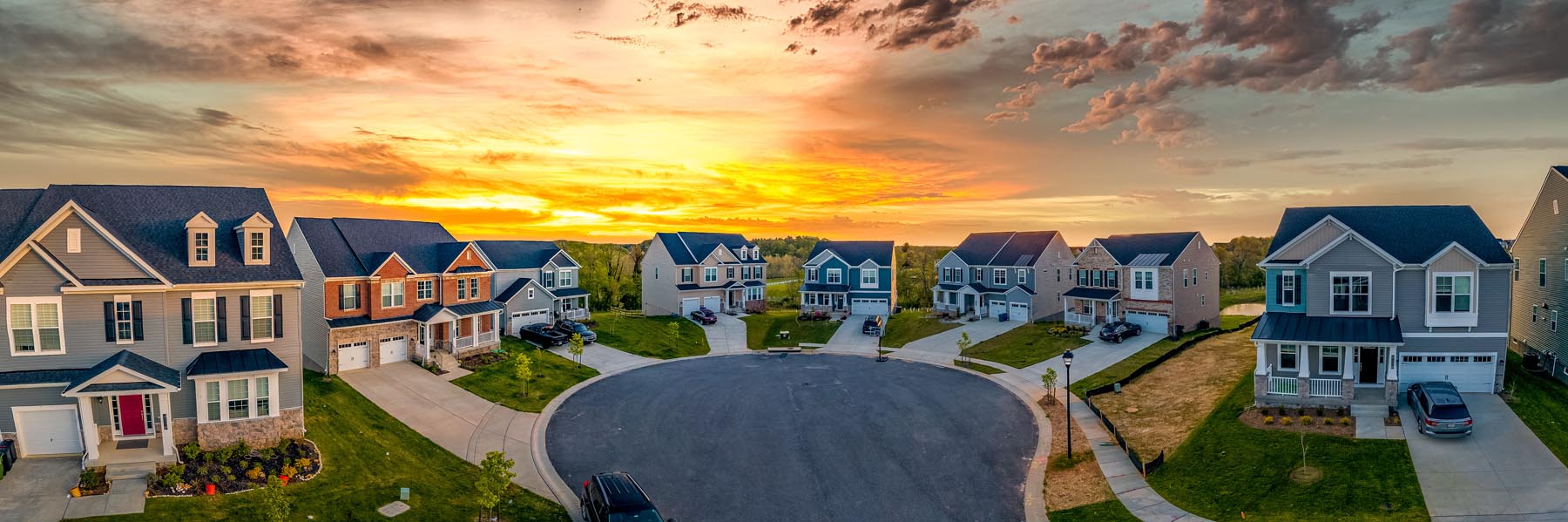 Houses arranged around a cul-de-sac at sunset.
