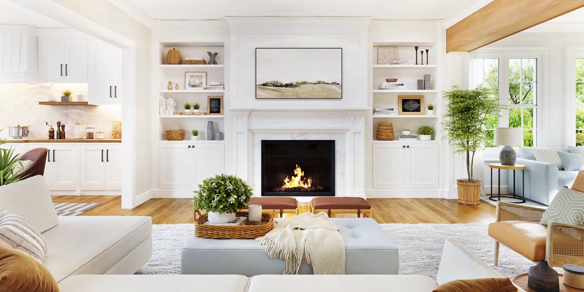 A living room with a fireplace, built-in shelves, and a view into the kitchen.